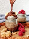 Delicious chia pudding with chocolate & peanut butter flavors. Vegan, gluten free & easy to make. Topped with fresh raspberries & creamy chocolate sauce, it's simply the perfect healthy treat for breakfast, brunch or dessert. 💛| inlovewithbliss.com #vegan #breakfast #healthy #chocolate #lowcarb